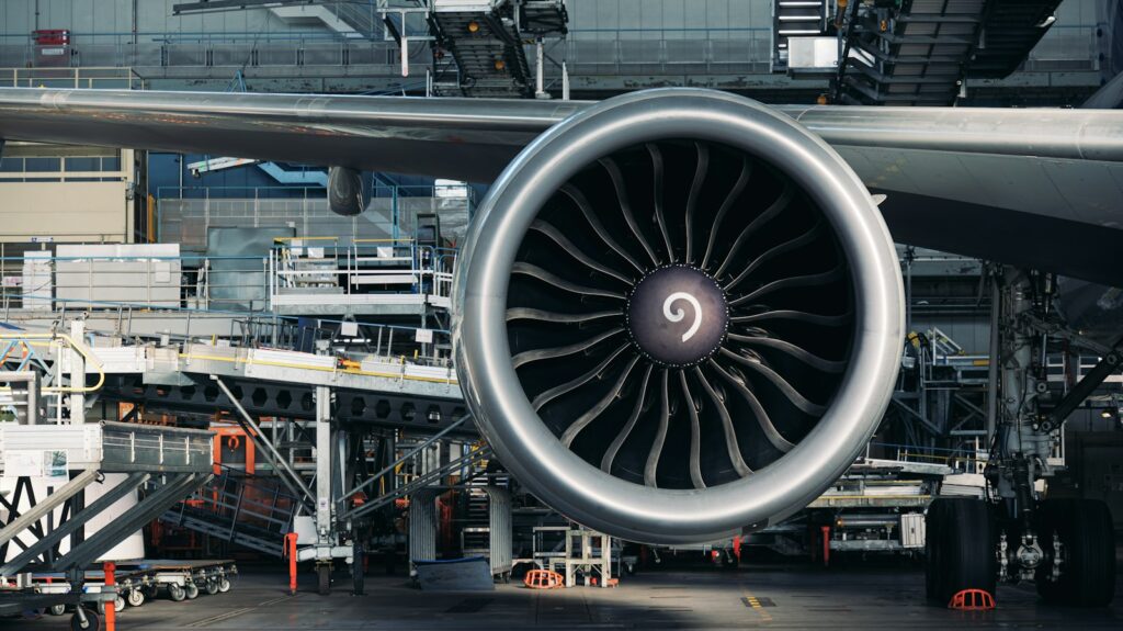 A large jet engine sitting on an airport tarmac, typical of aerospace components