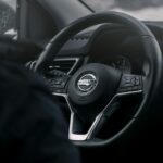 Black Nissan steering wheel, the part of the car where drivers notice steering play